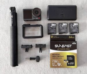 DJI Osmo Action 5 Pro action camera with dual OLED screens, wireless microphone, and Adventure Combo accessories – excellent condition