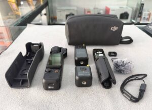 DJI Osmo Pocket 3 Creator Combo with 1-inch CMOS sensor, DJI Mic 2, wide lens, battery handle, and mini tripod – very good condition